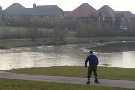 in-line skating beside icy lake